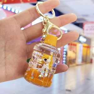 Detailed close-up of a Shiba Inu charm in a water bottle keychain with orange liquid