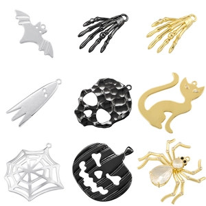 Detailed grid of 9 vintage Halloween charms including metal bats, skulls and spiders