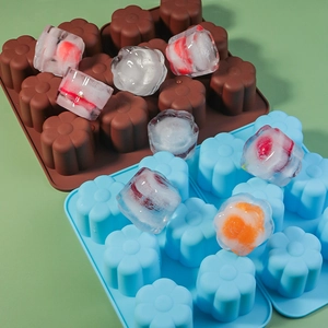 Detail of 15-cavity flower silicone mold with frozen ice cubes in blue and brown colors