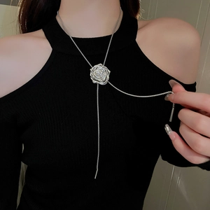 Silver metallic rose pendant necklace with adjustable pull chain on a model