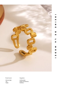 Macro detail of 18K gold plated hollow geometric ring with fine sandblasted metal texture