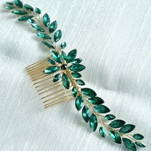 Detailed close-up of handmade bridal hair comb with emerald green crystal leaves
