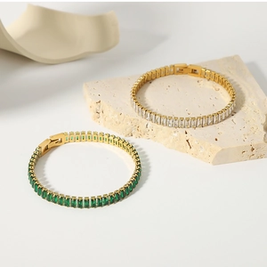 Detailed macro view of 18K gold plated bracelet with green rectangle zircon inlay