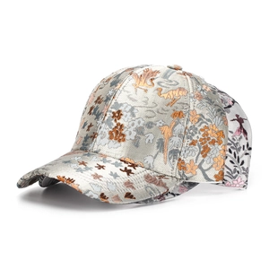 Close-up of intricate floral embroidery on vintage brocade fabric of the baseball cap