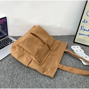 Detailed view of the large capacity canvas tote bag with functional outer pockets