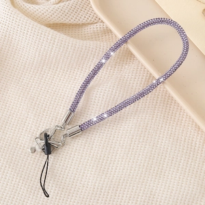 Detailed view of luxury purple rhinestone wrist strap for phone and keys with silver clasp