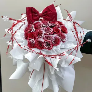 Holiday red rose bouquet with velvet bow, sequins and snowflakes for Christmas decor
