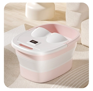 Pink foldable foot bath bucket with digital temperature display showing 38 degrees Celsius