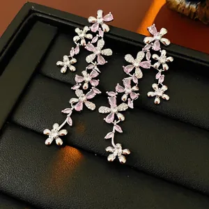 Elegant floral drop earrings with pink cubic zirconia tassels and silver flower design
