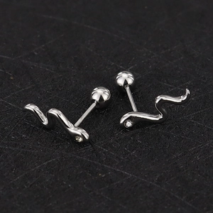 Macro detail of snake-shaped silver stud earrings with zircon head and screw back balls