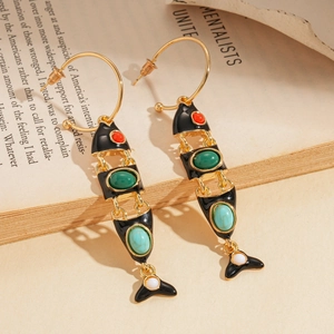 Detailed close-up of fishbone earrings with colorful gemstones and black enamel inlay