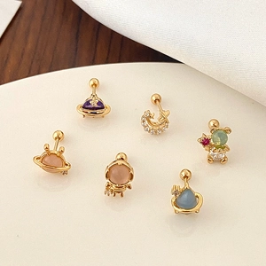 Detail of colorful zircon stud earrings with bear, planet and astronaut designs