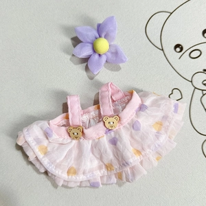 Detailed view of pink doll dress with polka dots, bear buttons and wooden details