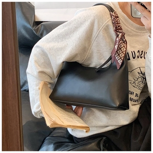 Minimalist black PU leather underarm bag with decorative printed silk scarf detail