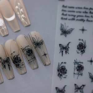 Ink style nail art stickers with butterfly and rose designs on light pink nails