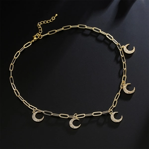 Gold plated link necklace with five sparkling zircon crescent moon charms on black background
