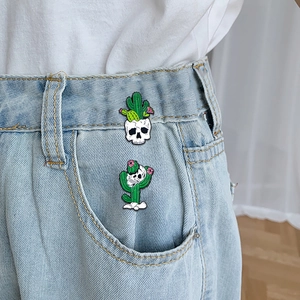 Punk cactus skull enamel pins on denim jeans featuring creative desert skull designs