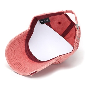 Detail of pink washed denim baseball cap with EVUP label and adjustable metal buckle