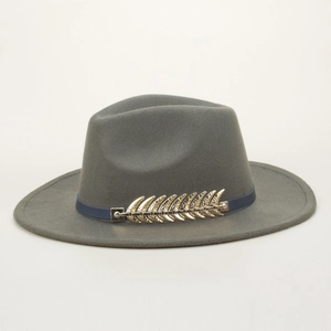 Detail of grey fedora wool hat with blue leather band and golden metal leaf ornament
