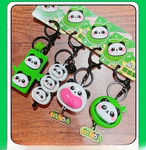 Detail view of four cute panda squishy charms with green bamboo accents and keychains