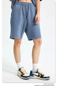 Macro detail of drawstring waistband and washed texture on gray-blue cotton gym shorts