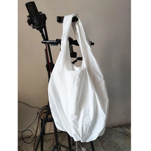 Detailed view of the pleated white canvas fabric texture on a large capacity tote bag