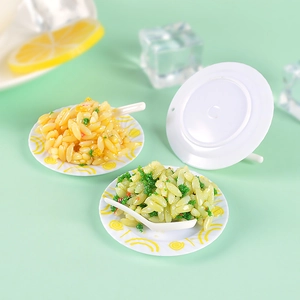 Miniature fried rice food models with spoons on a fresh mint green background