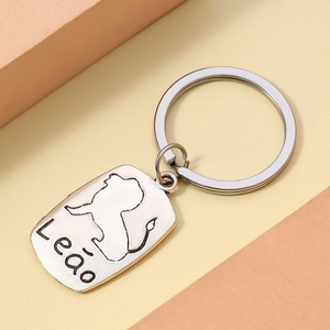 Macro detail of silver Leo zodiac keychain with engraved lion totem and metal ring