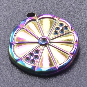 Macro shot of a lemon slice pendant with rainbow plating and blue rhinestones