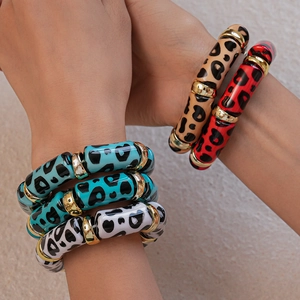 Close-up of leopard print acrylic beaded stretch bracelets with golden metal spacers