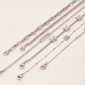 Detailed shot of stainless steel bracelets with butterfly charms and cubic zirconia stones