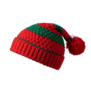 Detail of red and green striped knit Santa hat with a soft top pompom for Christmas