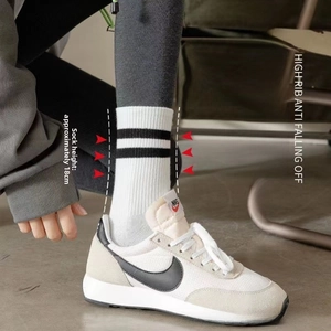Detail of white cotton athletic socks with black stripes and 18cm height ribbed cuff