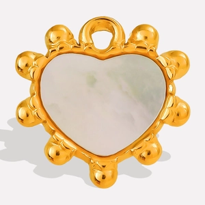 Detailed macro view of heart-shaped white shell pendant with beaded gold frame finish