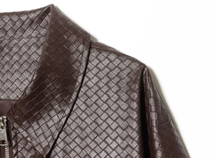 Detailed view of dark brown woven faux leather jacket collar and silver metal zipper