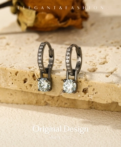 Macro detail of S925 sterling silver stamp on vintage black hoop earring with moissanite