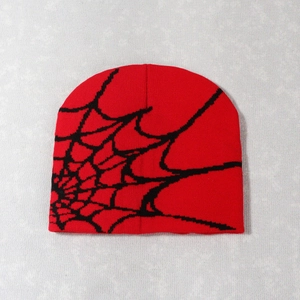 Close-up of red and black spider web jacquard pattern on high-quality knitted beanie hat