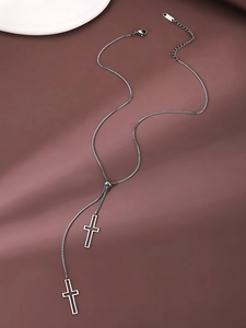 Close-up of adjustable silver stainless steel Y-necklace with cross pendants