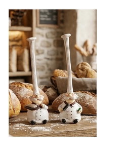 Detailed resin chef figurines with tall hats and kitchen tools in a bakery setting