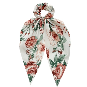Floral print hair scrunchie with long ribbons featuring pink rose patterns on white fabric