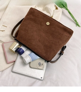 Interior view of large capacity dark brown suede tote bag showing tablet and cosmetics