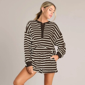 Close-up of brown striped knitted top featuring button detail and soft ribbed texture