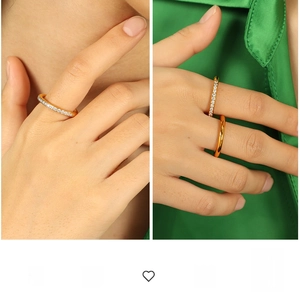Close-up of gold-plated stacked rings with pavé set crystals and polished finish
