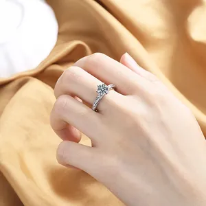 Close-up of six-prong heart cubic zirconia ring with twisted band on female finger