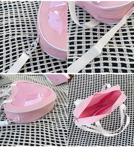 Detail views of pink heart-shaped ita bag showing canvas texture and adjustable strap