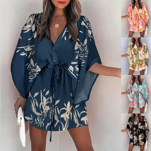Detail of V-neck ruffled sleeve floral romper and short dress with waist tie and prints