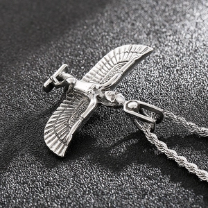Macro shot of silver Faravahar pendant with intricate wings and sparkling rhinestones
