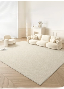 Detailed top view of cream-colored woven rug texture on light wood flooring