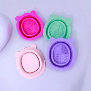 Set of four colorful bear-shaped silicone makeup brush cleaning bowls with foldable design