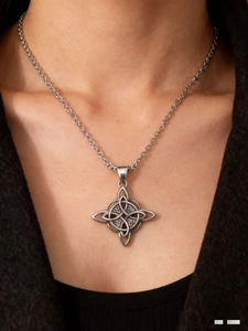 Close-up of vintage Celtic knot pendant necklace in antique silver finish on a male model